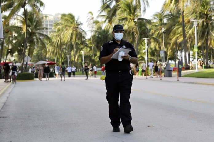 Miami Beach code compliance officer, walks along Ocean Drive